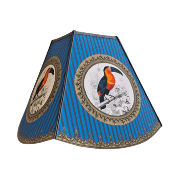 Decorative blue striped lampshade with circular toucan illustrations in tan frames.